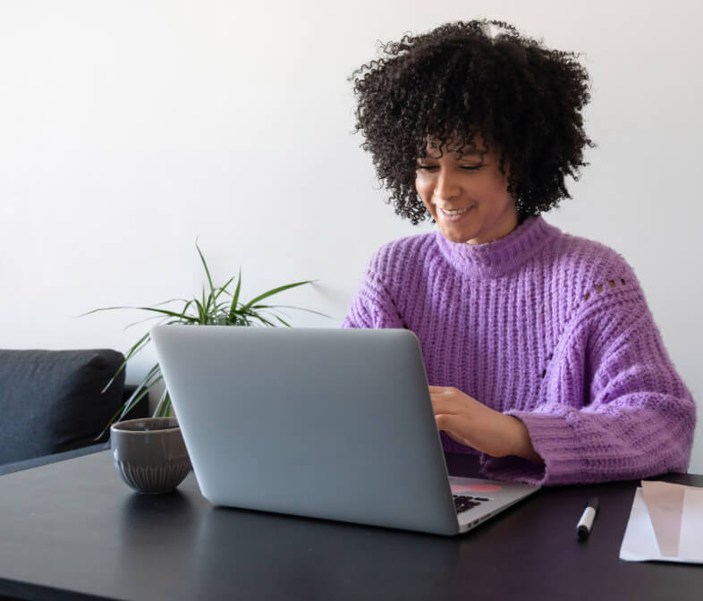 Woman working professional sitting and working on a table along with her laptop.