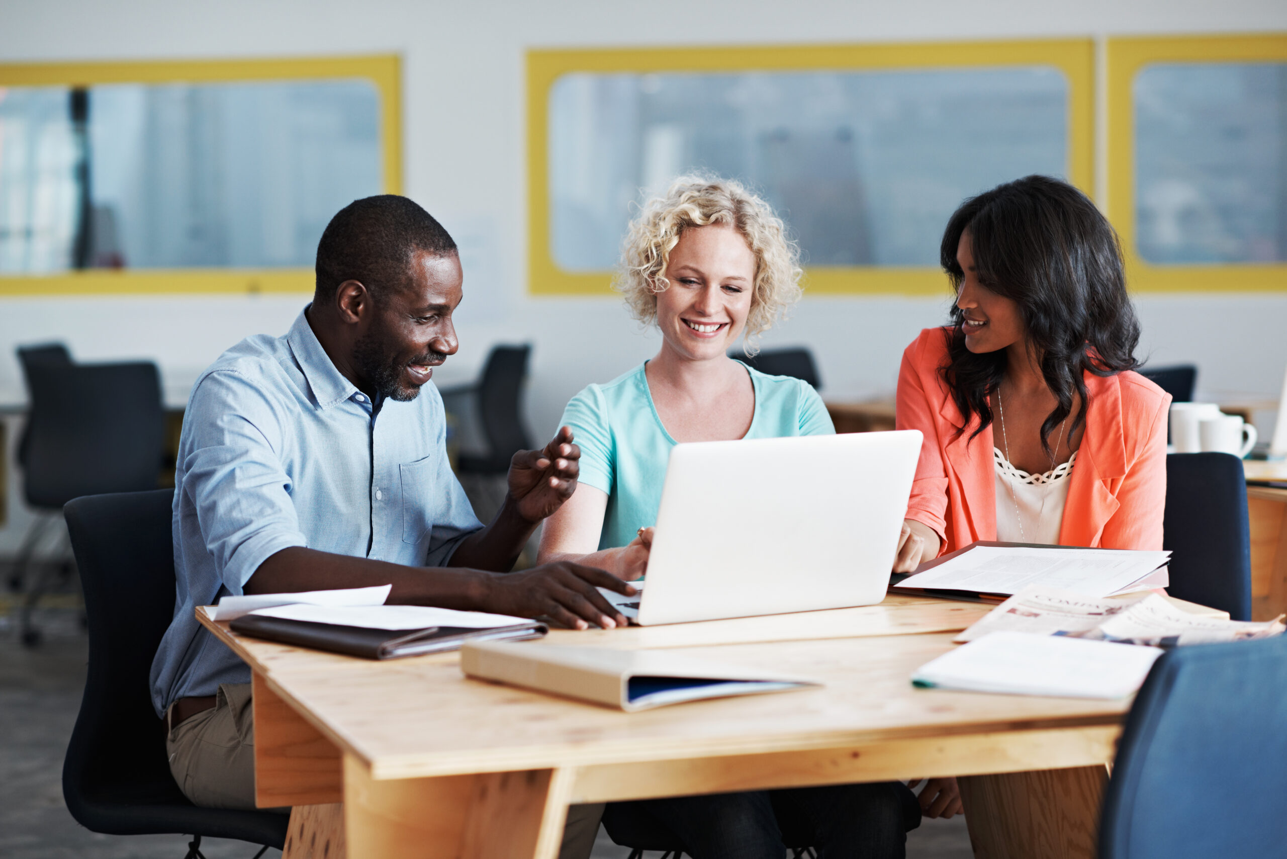 Diverse office works collaborating around a table