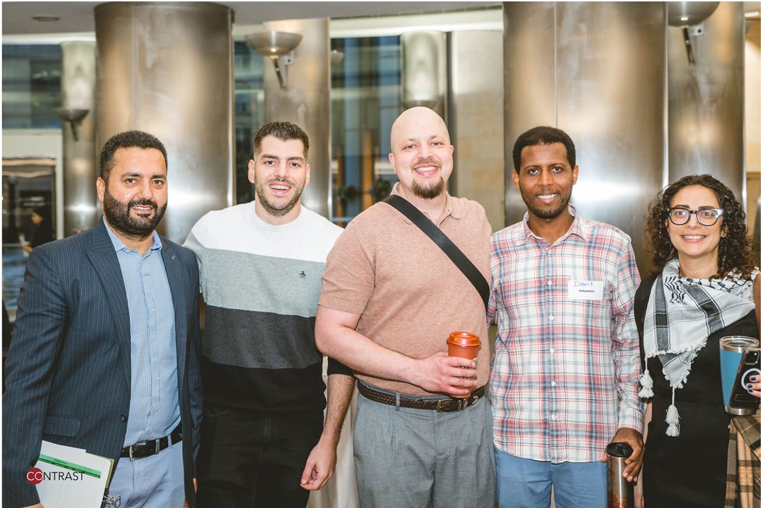 A group of students pose for the camera and smile