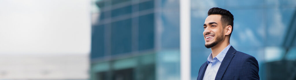 Young man smiles outdoors