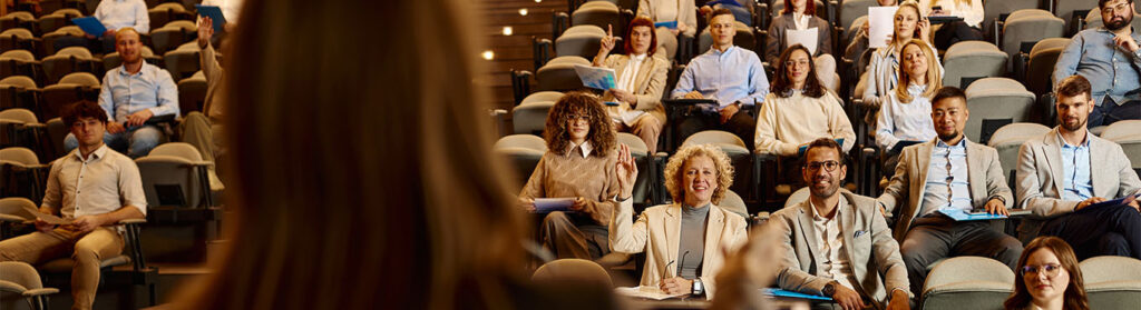 Students listen to a professor in a lecture hall
