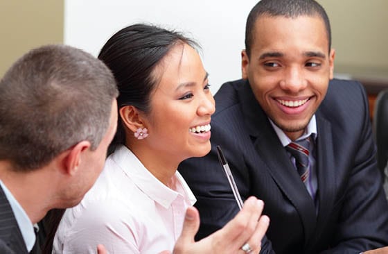 Professionals talking and smiling in a meeting
