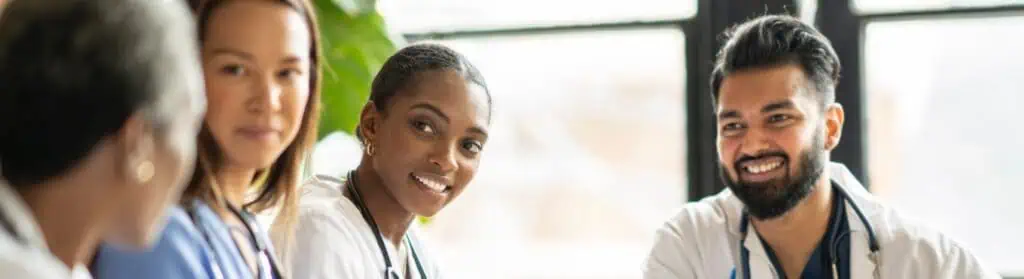 A group of medical professionals confer around a table